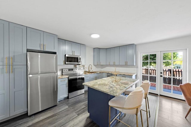 2548 Katherine Ct, El Cajon, CA 92020 - kitchen featuring appliances with stainless steel finishes, wood finished floors, french doors, a center island, and a kitchen breakfast bar