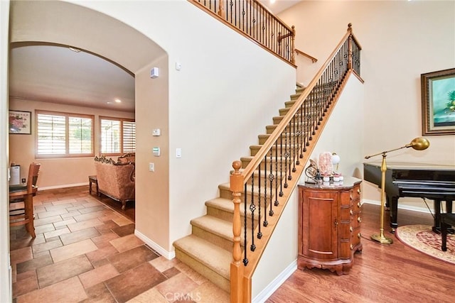 12430 Split Rein Dr, Rancho Cucamonga, CA 91739 - stairs with baseboards, arched walkways, and recessed lighting