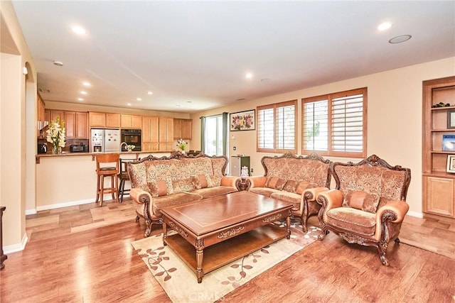 12430 Split Rein Dr, Rancho Cucamonga, CA 91739 - living room featuring light wood-style floors, recessed lighting, and baseboards
