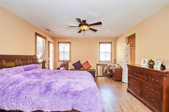 12430 Split Rein Dr, Rancho Cucamonga, CA 91739 - bedroom featuring multiple windows, light wood-style floors, and a ceiling fan