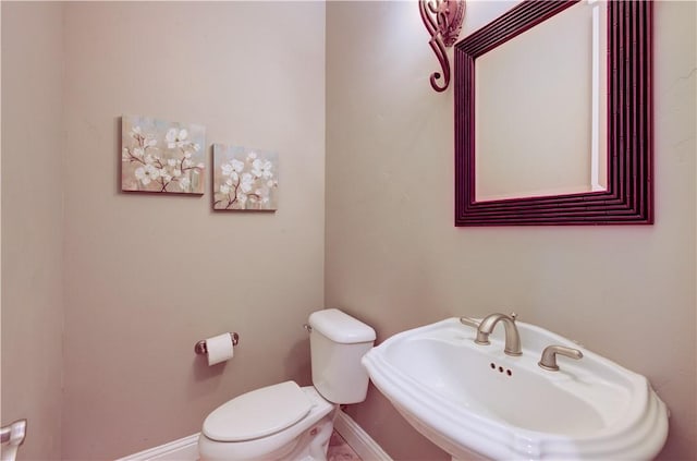 2096 E Olympic Ave, Fresno, CA 93730 - half bathroom with toilet, baseboards, and a sink