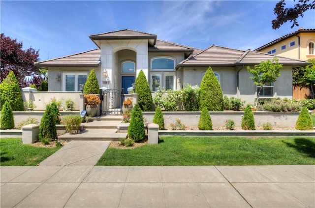 2096 E Olympic Ave, Fresno, CA 93730 - mediterranean / spanish home with a tile roof, stucco siding, and a gate