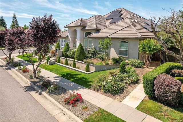 2096 E Olympic Ave, Fresno, CA 93730 - view of front of home featuring stucco siding, a tiled roof, and a front yard