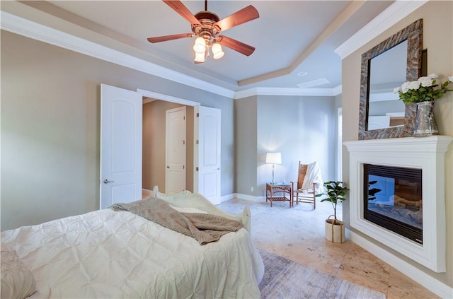 2096 E Olympic Ave, Fresno, CA 93730 - bedroom featuring baseboards, ornamental molding, ceiling fan, a glass covered fireplace, and a tray ceiling