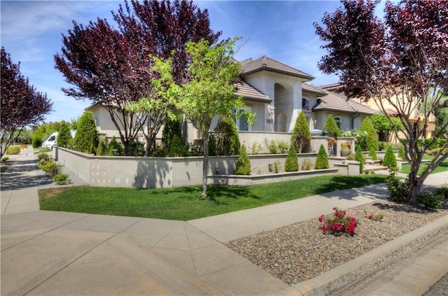 2096 E Olympic Ave, Fresno, CA 93730 - view of front of home featuring a tiled roof and stucco siding
