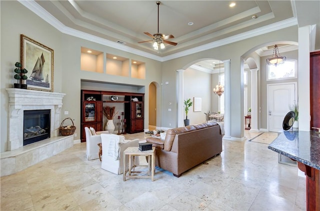 2096 E Olympic Ave, Fresno, CA 93730 - living area featuring ornate columns, arched walkways, ornamental molding, a raised ceiling, and a ceiling fan