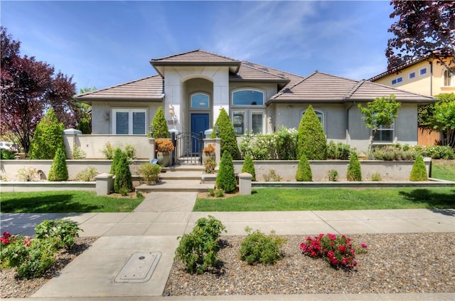 2096 E Olympic Ave, Fresno, CA 93730 - mediterranean / spanish-style house with stucco siding, a tile roof, and a gate