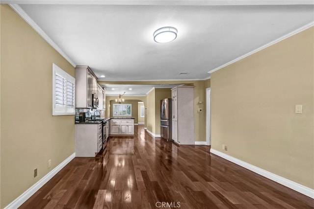 3163 La Clede Ave, Los Angeles, CA 90039 - unfurnished living room with ornamental molding, dark wood finished floors, a chandelier, baseboards, and arched walkways