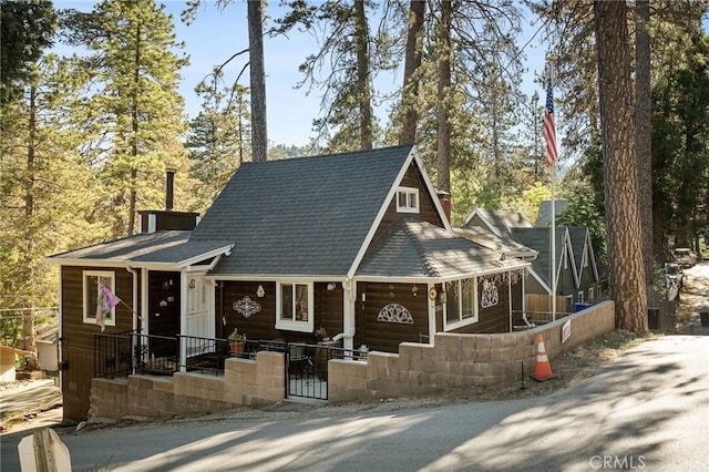 22864 Alder Ln, Crestline, CA 92325 - view of front of house featuring a fenced front yard, roof with shingles, and a gate