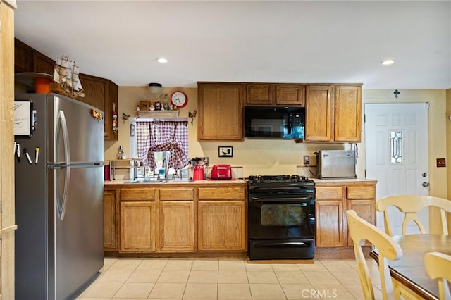 22864 Alder Ln, Crestline, CA 92325 - kitchen with black appliances, a sink, light countertops, light tile patterned floors, and brown cabinetry