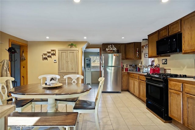 22864 Alder Ln, Crestline, CA 92325 - kitchen featuring black appliances, light tile patterned floors, recessed lighting, a sink, and light countertops