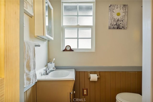 22864 Alder Ln, Crestline, CA 92325 - bathroom with toilet, vanity, and a wainscoted wall