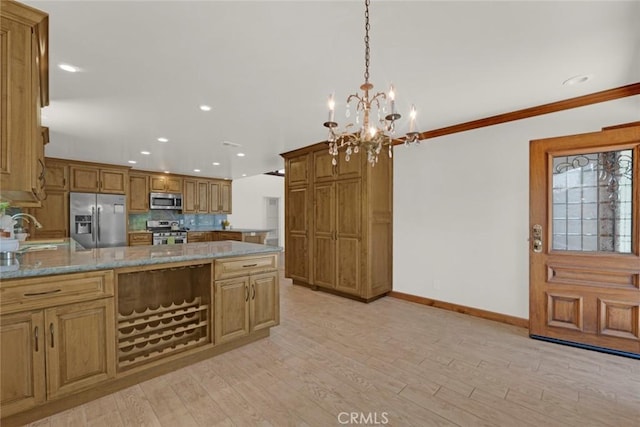 8402 Mcgroarty St, Sunland, CA 91040 - kitchen featuring appliances with stainless steel finishes, tasteful backsplash, a chandelier, a sink, and baseboards