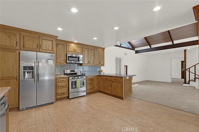 8402 Mcgroarty St, Sunland, CA 91040 - kitchen featuring appliances with stainless steel finishes, open floor plan, light wood finished floors, a peninsula, and brown cabinetry