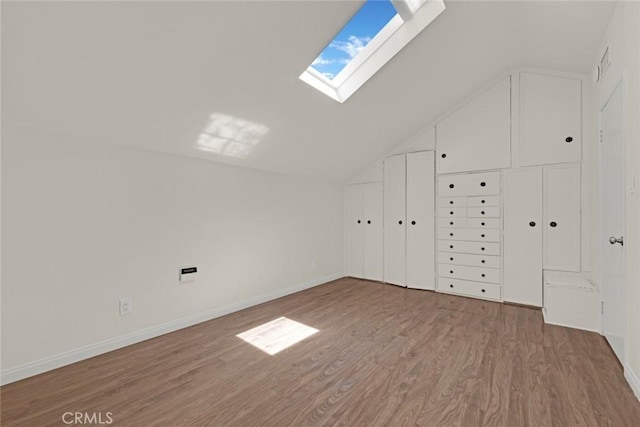 8402 Mcgroarty St, Sunland, CA 91040 - additional living space featuring a skylight, lofted ceiling, wood finished floors, and baseboards