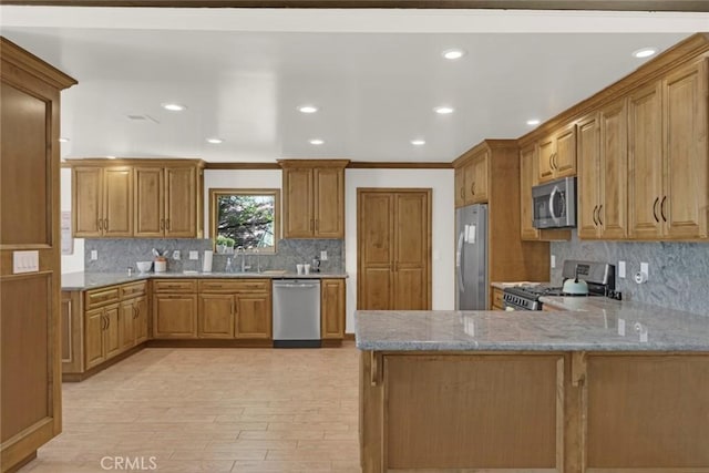 8402 Mcgroarty St, Sunland, CA 91040 - kitchen with appliances with stainless steel finishes, backsplash, light stone counters, a peninsula, and recessed lighting