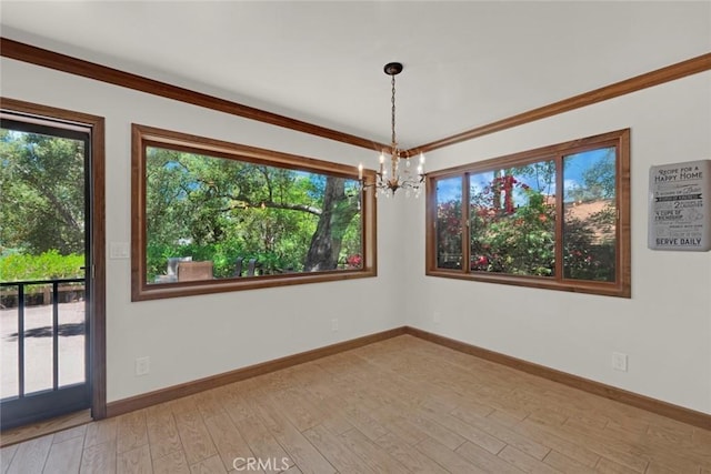 8402 Mcgroarty St, Sunland, CA 91040 - unfurnished room featuring a chandelier, plenty of natural light, light wood-style flooring, and ornamental molding