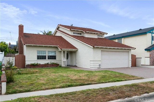 20619 Entradero Ave, Torrance, CA 90503 - mediterranean / spanish house featuring a garage, a tile roof, driveway, and stucco siding