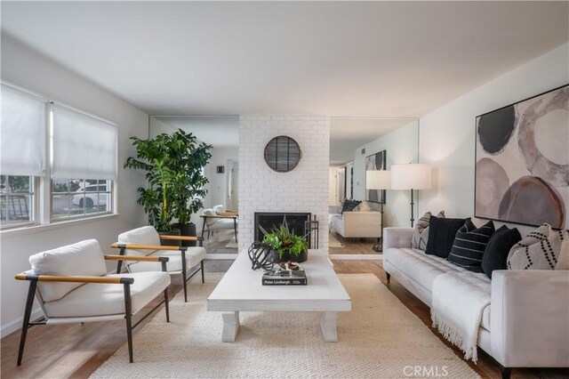 20619 Entradero Ave, Torrance, CA 90503 - living area with light wood-type flooring, a fireplace, and baseboards