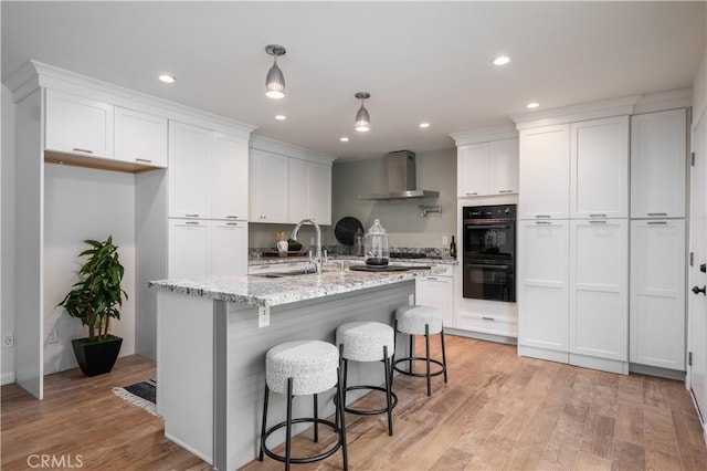 20619 Entradero Ave, Torrance, CA 90503 - kitchen with wall chimney exhaust hood, white cabinets, light wood-style flooring, and recessed lighting