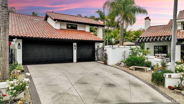 28021 Camino Santo Domingo, San Juan Capistrano, CA 92675 - mediterranean / spanish-style house with a tiled roof, stucco siding, concrete driveway, and a gate