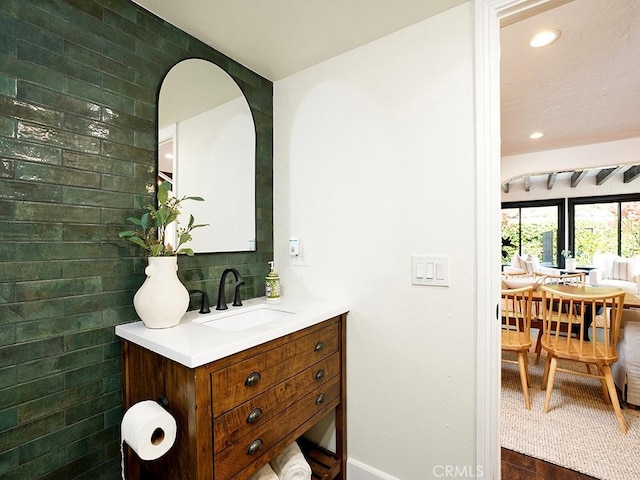 28021 Camino Santo Domingo, San Juan Capistrano, CA 92675 - bathroom featuring vanity, baseboards, recessed lighting, wood finished floors, and tasteful backsplash