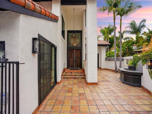 28021 Camino Santo Domingo, San Juan Capistrano, CA 92675 - doorway to property with stucco siding, a tile roof, and a patio