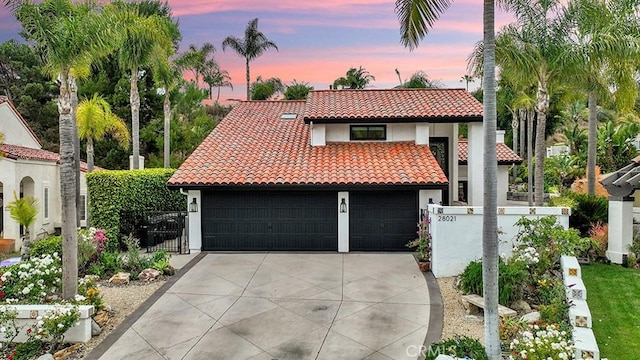 28021 Camino Santo Domingo, San Juan Capistrano, CA 92675 - mediterranean / spanish home featuring a tile roof, stucco siding, concrete driveway, and a gate