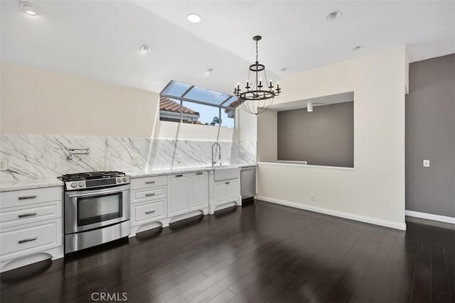 24851 Seagate Dr, Dana Point, CA 92629 - kitchen featuring stainless steel range with gas stovetop, tasteful backsplash, baseboards, a chandelier, and light stone countertops