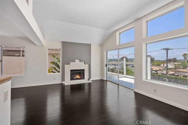 24851 Seagate Dr, Dana Point, CA 92629 - unfurnished living room featuring wood finished floors, baseboards, lofted ceiling, and a fireplace