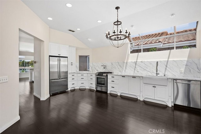 24851 Seagate Dr, Dana Point, CA 92629 - kitchen featuring stainless steel appliances, a sink, tasteful backsplash, a chandelier, and lofted ceiling