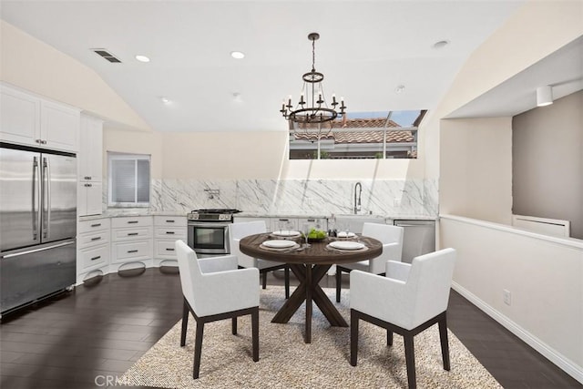 24851 Seagate Dr, Dana Point, CA 92629 - dining space with dark wood finished floors, a chandelier, vaulted ceiling, recessed lighting, and baseboards