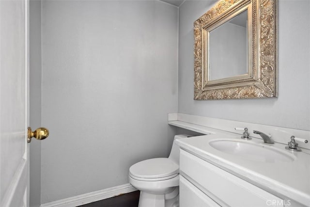 24851 Seagate Dr, Dana Point, CA 92629 - half bathroom with vanity, toilet, and baseboards