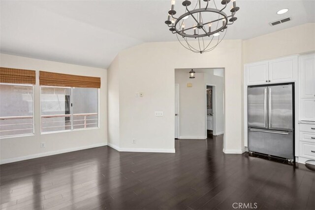 24851 Seagate Dr, Dana Point, CA 92629 - unfurnished living room featuring dark wood-type flooring, a chandelier, vaulted ceiling, and baseboards
