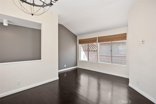24851 Seagate Dr, Dana Point, CA 92629 - unfurnished room featuring wood finished floors, lofted ceiling, baseboards, and a chandelier