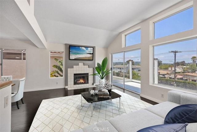 24851 Seagate Dr, Dana Point, CA 92629 - living area with baseboards, a fireplace, wood finished floors, and vaulted ceiling
