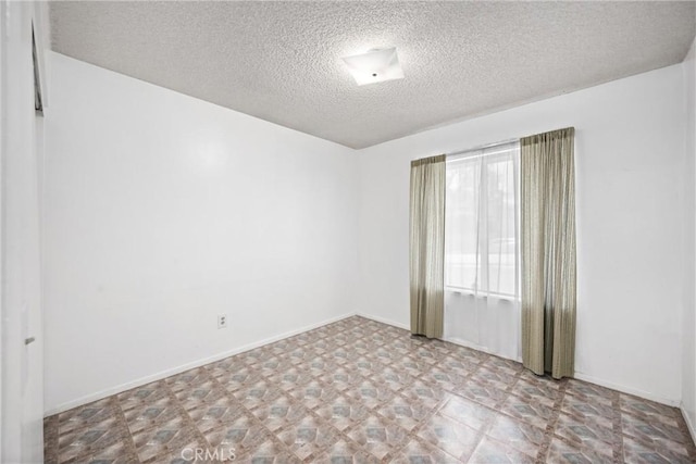 6145 Jasper St, Rancho Cucamonga, CA 91701 - empty room with a textured ceiling, tile patterned floors, and baseboards