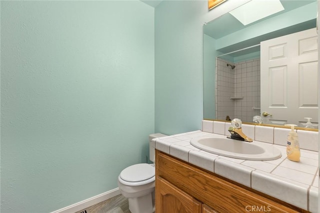 1585 Gate Ln, Paradise, CA 95969 - bathroom featuring toilet, a shower, baseboards, vanity, and a skylight