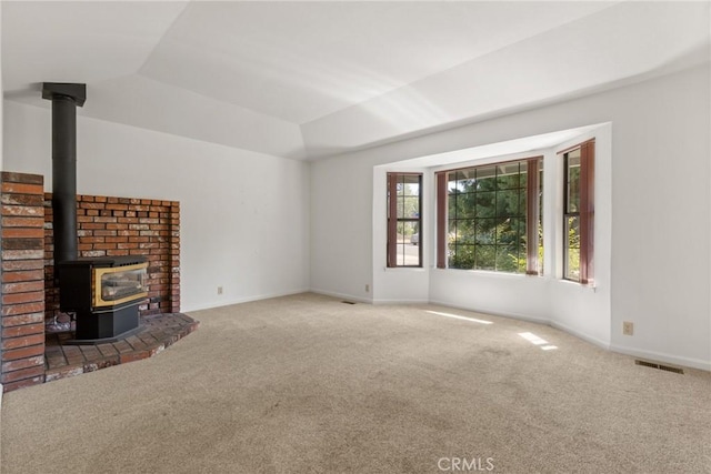 1585 Gate Ln, Paradise, CA 95969 - unfurnished living room with carpet, a wood stove, lofted ceiling, and baseboards
