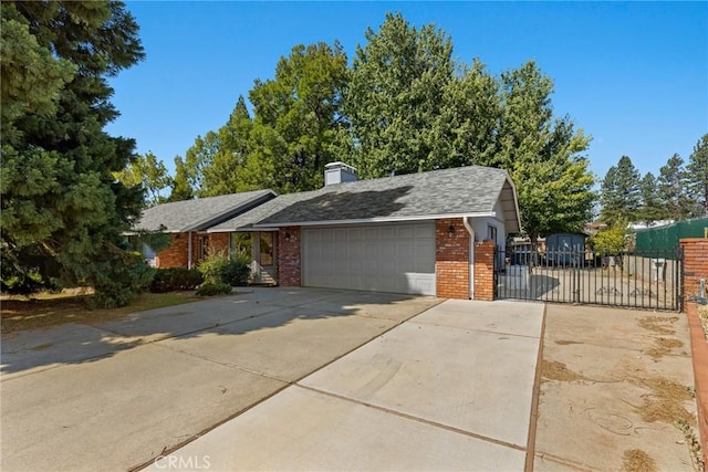 1585 Gate Ln, Paradise, CA 95969 - view of front of house featuring a gate, brick siding, a garage, concrete driveway, and a chimney