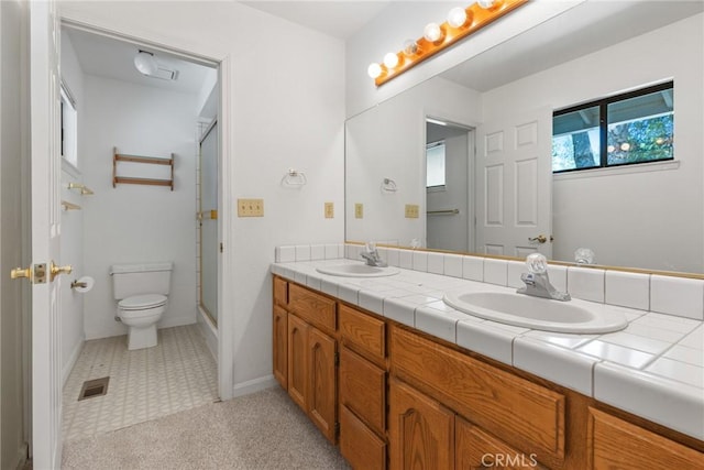 1585 Gate Ln, Paradise, CA 95969 - bathroom featuring toilet, a shower with door, double vanity, and baseboards