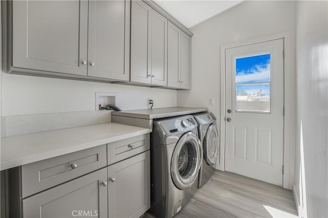 9809 Odessa Ave, North Hills, CA 91343 - laundry area featuring cabinet space, washer and clothes dryer, and light wood finished floors