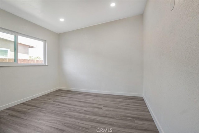 9809 Odessa Ave, North Hills, CA 91343 - spare room with wood finished floors, baseboards, and recessed lighting