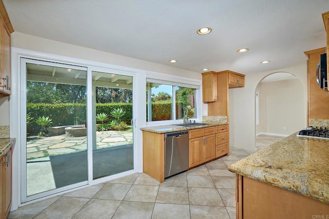 723 Fresca Ct, Solana Beach, CA 92075 - kitchen featuring stainless steel appliances, a sink, light stone countertops, arched walkways, and recessed lighting