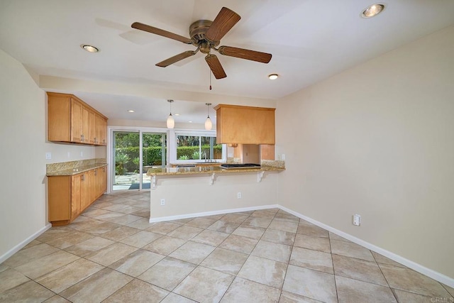 723 Fresca Ct, Solana Beach, CA 92075 - kitchen with a peninsula, ceiling fan, light tile patterned floors, light stone counters, and recessed lighting