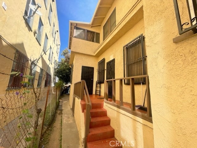 1835 W 12th St, Los Angeles, CA 90006 - doorway to property featuring stucco siding and central AC