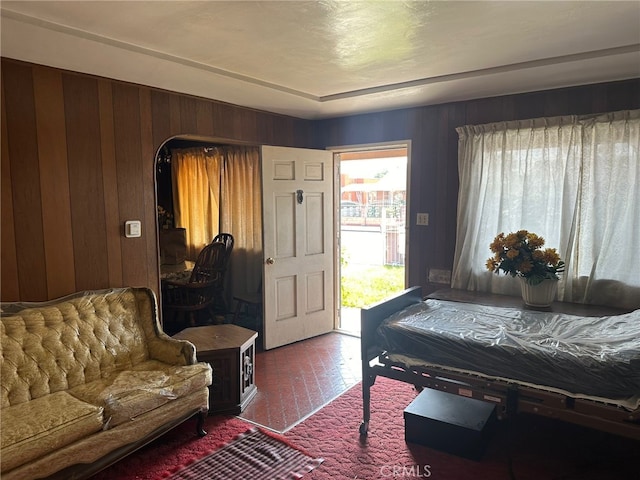 2549 Kansas Ave, South Gate, CA 90280 - bedroom featuring brick flooring, access to exterior, and wood walls