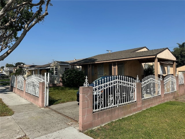 2549 Kansas Ave, South Gate, CA 90280 - view of front of home featuring a gate, roof with shingles, and stucco siding