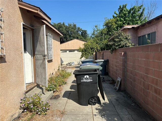 2549 Kansas Ave, South Gate, CA 90280 - view of patio featuring entry steps, a garage, and an outbuilding