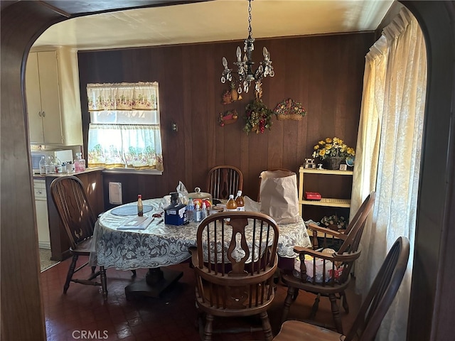 2549 Kansas Ave, South Gate, CA 90280 - dining room with a chandelier, wood walls, and arched walkways